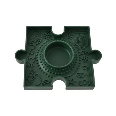 Green puzzle dog slow feeder enrichment bowl with raised texture and center feeding area