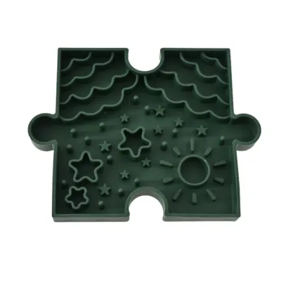 Green Puzzle Dog Slow Feeder Bowl White Background Green puzzle dog slow feeder bowl with raised patterns, star shapes, and food maze design on white background.