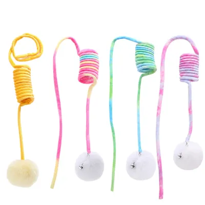 Four retractable cat teaser wands in yellow, pink, green, and purple with fluffy balls and bells