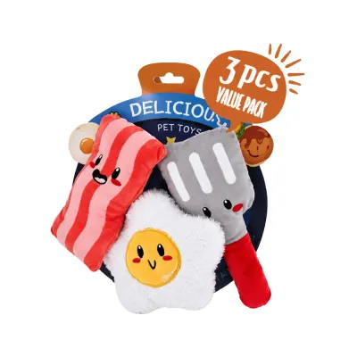 Three-piece breakfast plush dog toy set with bacon, fried egg and spatula toys in retail packaging