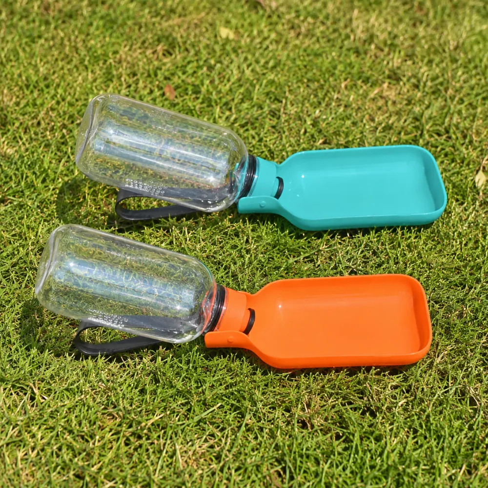 Portable Dog Water Bottles with Drinking Bowls Orange and teal portable dog water bottles opened into drinking bowls on outdoor grass