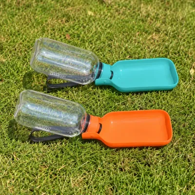 Orange and teal portable dog water bottles opened into drinking bowls on outdoor grass