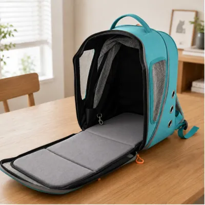 Open teal pet backpack carrier with a spacious interior, padded mat and safety leash