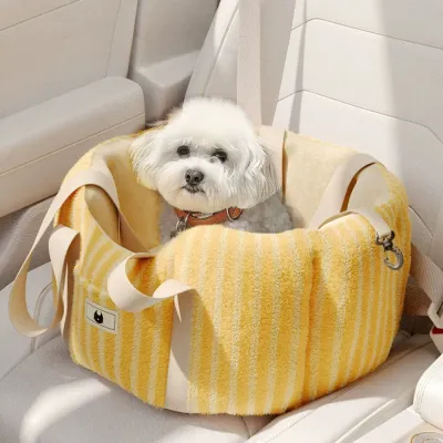 Small white dog sitting inside a yellow plush dog car seat carrier installed on a vehicle backseat.