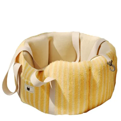 Portable yellow plush dog car seat carrier with padded walls, long carrying straps and safety leash attachment.