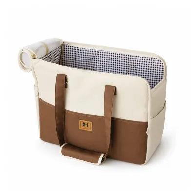 Brown and cream crossbody pet carrier with checkered lining, padded handles and front storage pocket.