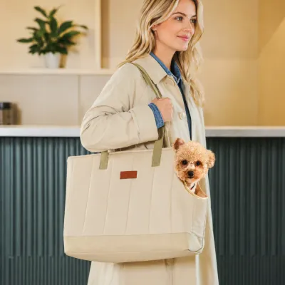 Lightweight Dog Carrier Tote for Small Dogs Woman carrying a small dog in a beige quilted dog carrier tote bag