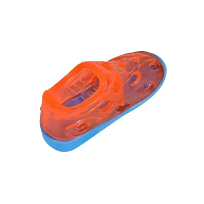 Orange shoe-shaped dog treat dispensing toy with a blue base on a white background