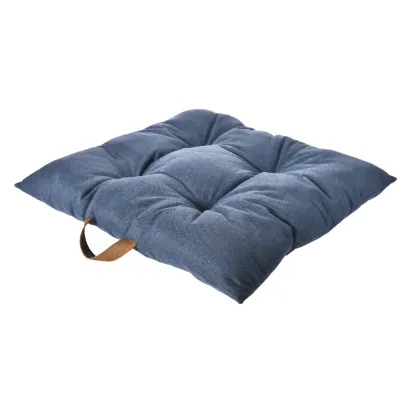 Soft blue tufted dog bed mat featuring plush padded sections and an integrated carry handle.