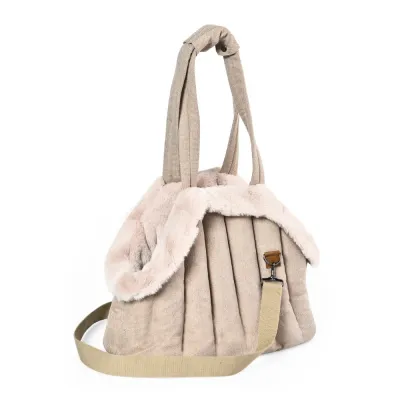 Angled view of a soft-sided beige dog carrier bag featuring plush trim, padded construction and shoulder strap.