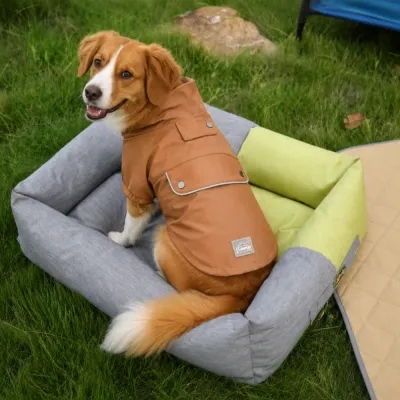 Dog Wearing Brown PU Raincoat Outdoors Medium-sized dog wearing a brown PU raincoat while sitting on an outdoor pet bed on the grass.