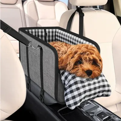 Small dog resting in a dog car booster seat secured between car seats