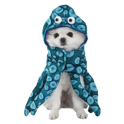 Small white dog wearing a blue plush octopus Halloween costume with hood and tentacles