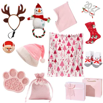 Pink Christmas pet and owner gift set with reindeer headband, Santa hat, blanket, socks, lick mat, dog toys and gift packaging.