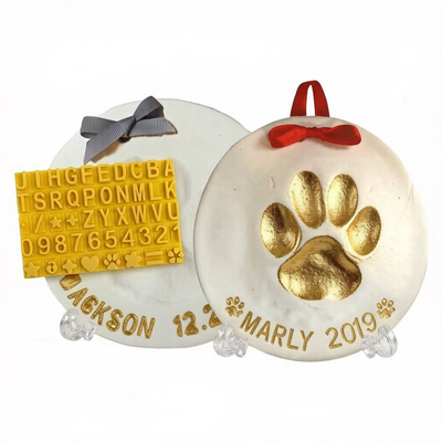 White Dog Paw Print Keepsake with Personalized Name White dog paw print keepsake with gold paw impression personalized name date ribbon and letter stamps