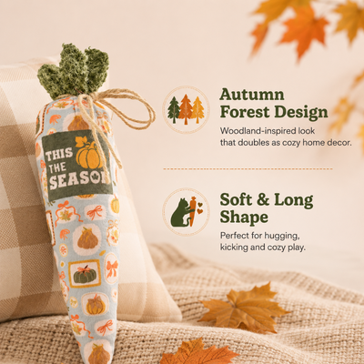 Soft Long Autumn Cat Toy for Cozy Play Long soft autumn cat toy with woodland-inspired design and pumpkin print displayed with fall leaves and neutral home decor