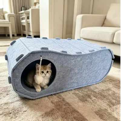 Felt Cat Tunnel Bed for Indoor Cats Kitten resting inside a grey felt cat tunnel bed with hanging pom pom toy in a living room