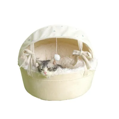 Gray cat resting inside a soft cream covered cradle cat bed with plush interior and canopy