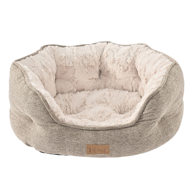 Soft beige dog bed with thick cushioned bolsters, rose-textured plush lining and low front entry on white background.