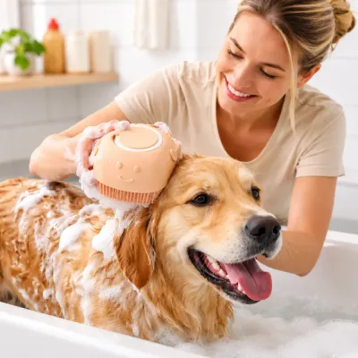 Woman using a silicone pet bath brush to wash a Golden Retriever with shampoo foam