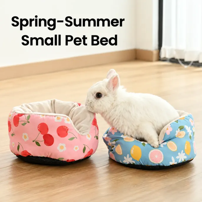 Cozy Rabbit Sofa Bed with Soft Cushioned Surrounding Sides White rabbit sitting in a blue lemon small pet sofa bed beside a pink cherry bed, showing the soft plush lining and padded sides.