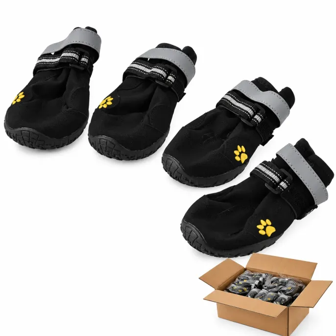 Wholesale Black Dog Boots Four Piece Set with Bulk Packaging Four black protective dog boots with gray reflective straps, yellow paw embroidery and textured rubber soles displayed alongside a bulk shipping carton.