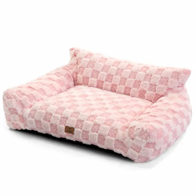 Pink Plush Pet Sofa Bed with Soft Bolstered Sides Pink plush dog and cat sofa bed with soft checkered fabric, raised bolstered sides and a cushioned sleeping surface.