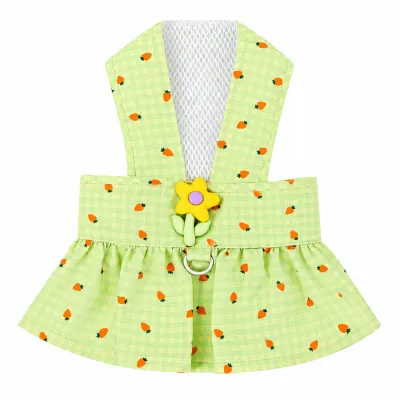 Light green plaid pet harness dress with orange carrot prints, white mesh panel, yellow flower decoration, metal D-ring and pleated skirt on a white background.