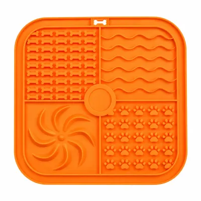 Orange Multi-Texture Slow Feeder Lick Mat for Dogs and Cats Orange square pet lick mat with four textured feeding sections featuring raised bone shapes, wavy grooves, swirl patterns, and paw prints on a white background.