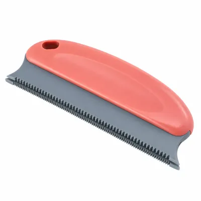 Pet Hair Remover Brush with Dual Sided Rubber Teeth Coral pink and gray pet hair remover brush featuring dual sided rubber teeth, an ergonomic grip, and a hanging hole on a white background.